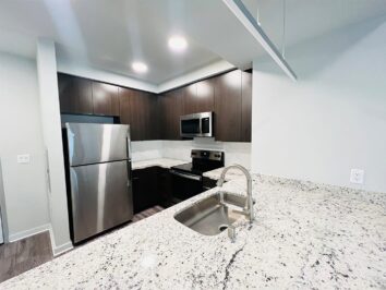 Apartment kitchen with dark cabinets