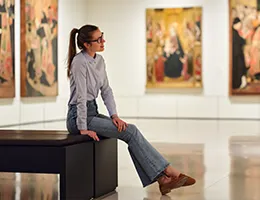young woman sitting in a museum