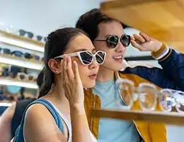 young adults shopping for sunglasses